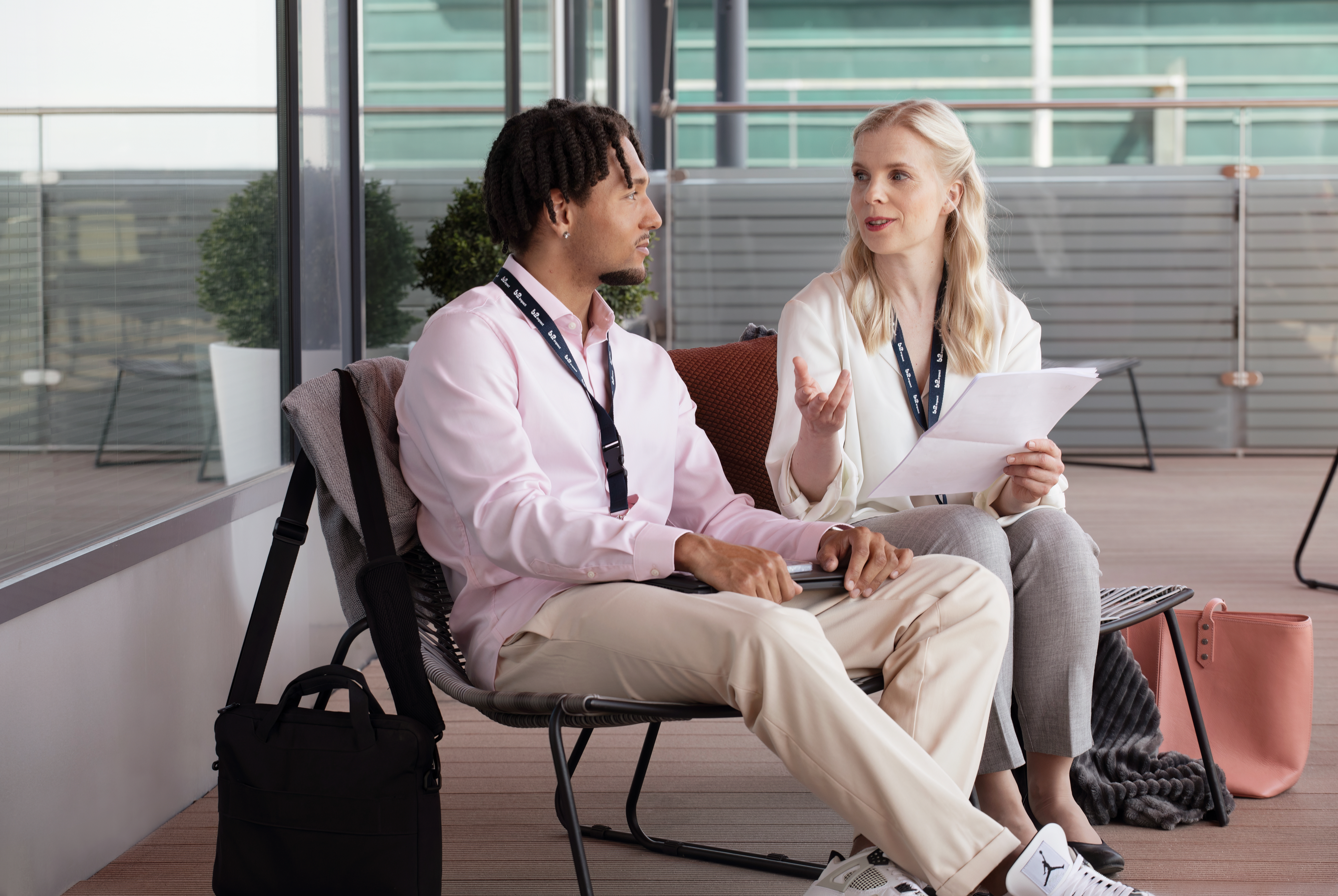 Two colleagues sitting on a sofa discussing