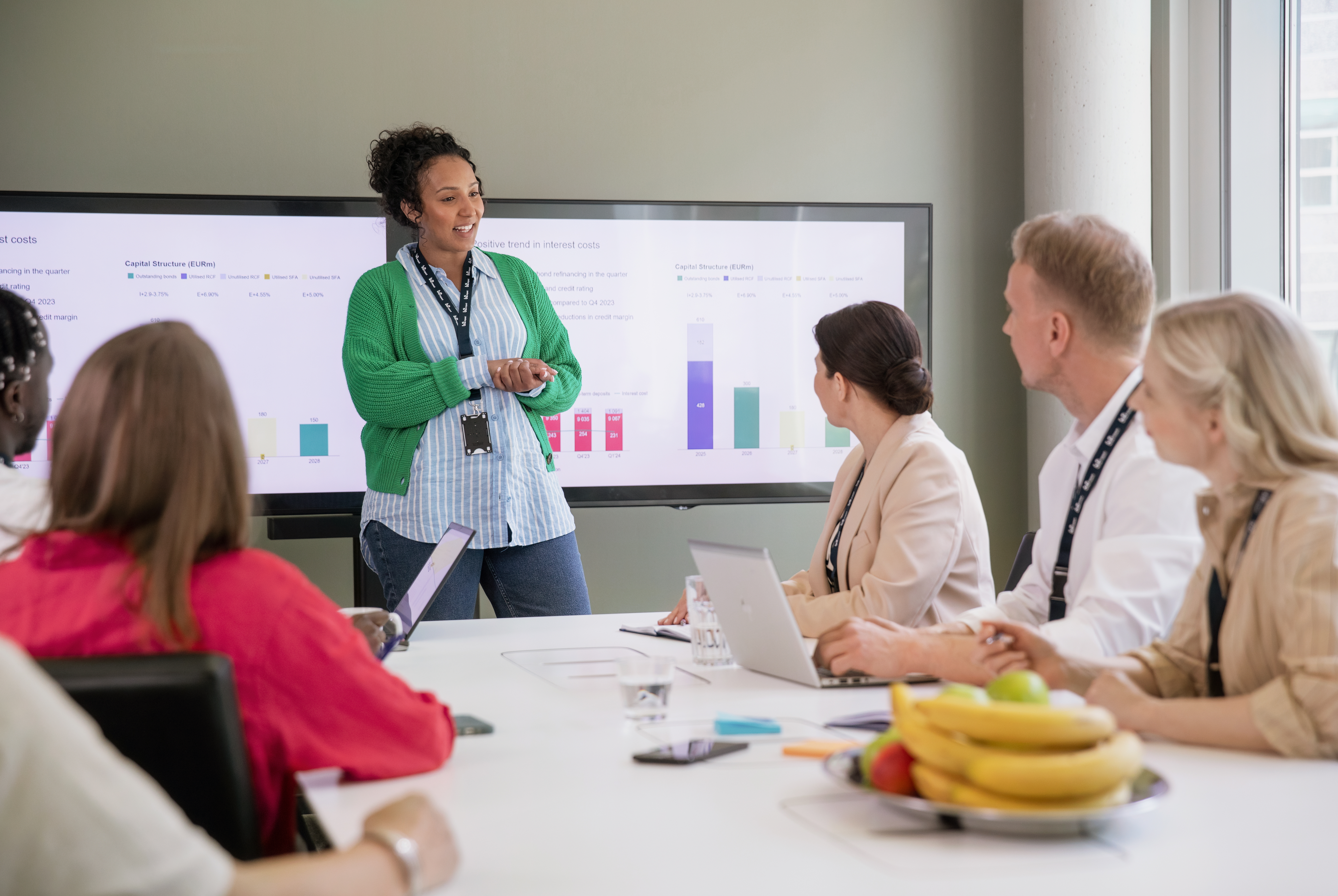 A woman presenting something in a meeting room