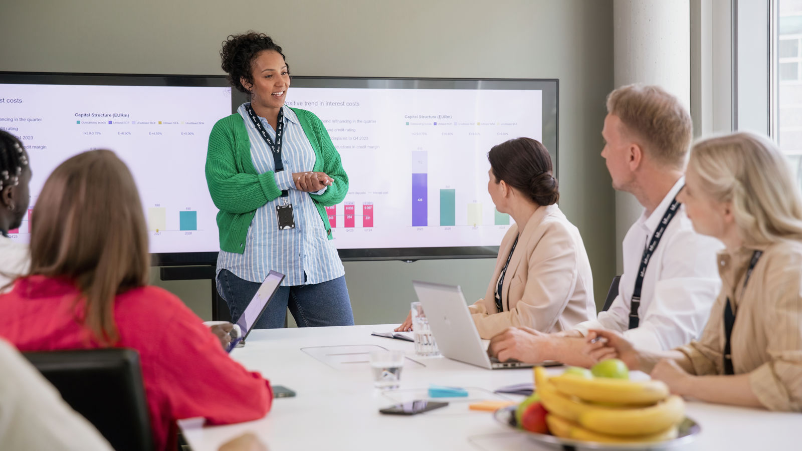 A woman presenting something in a meeting room