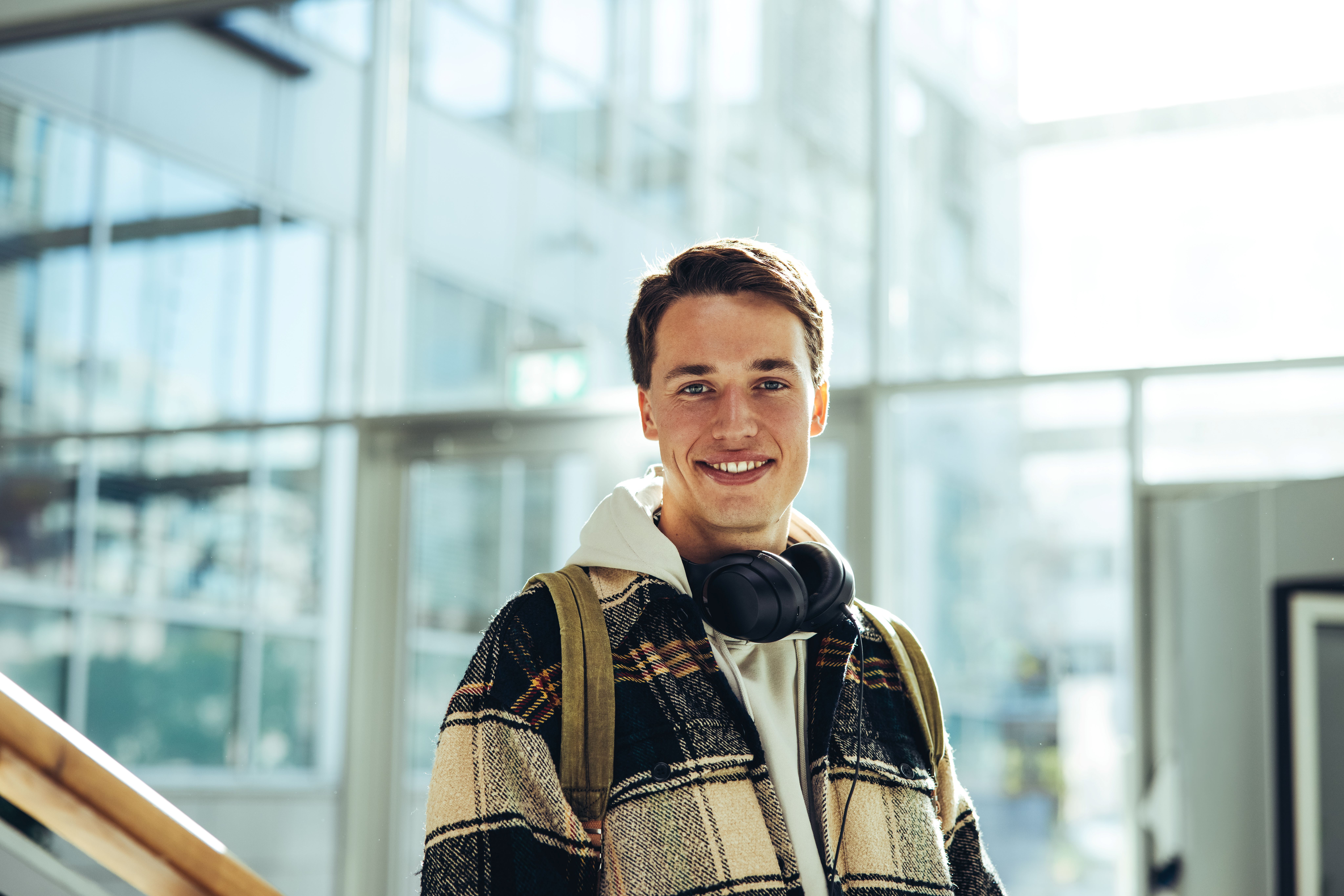 Young man in front of a modern building