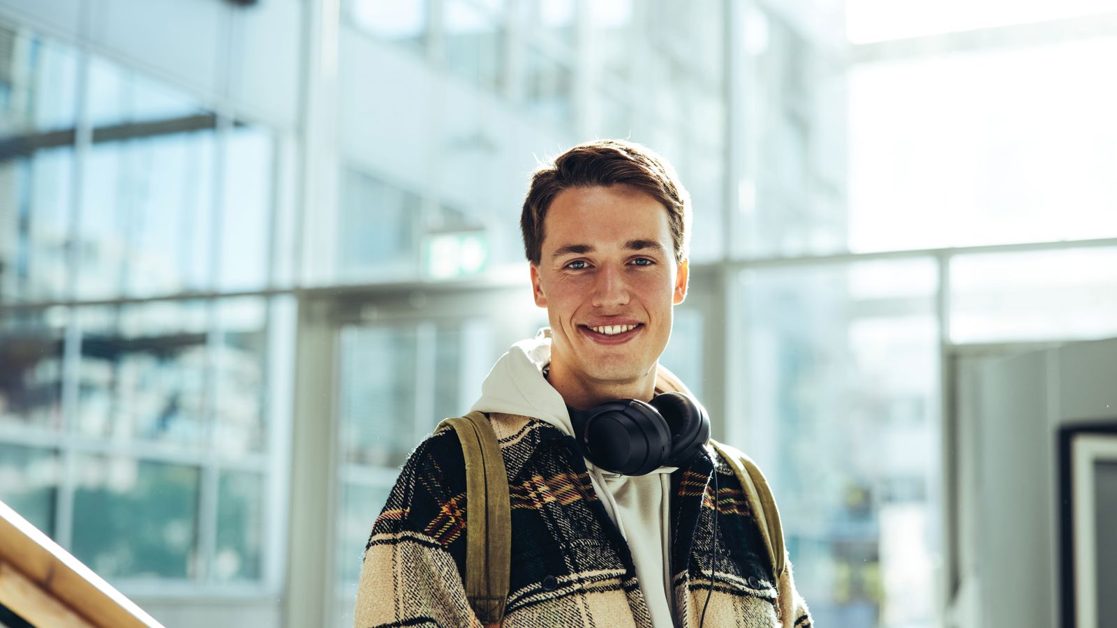 Young man in front of a modern building
